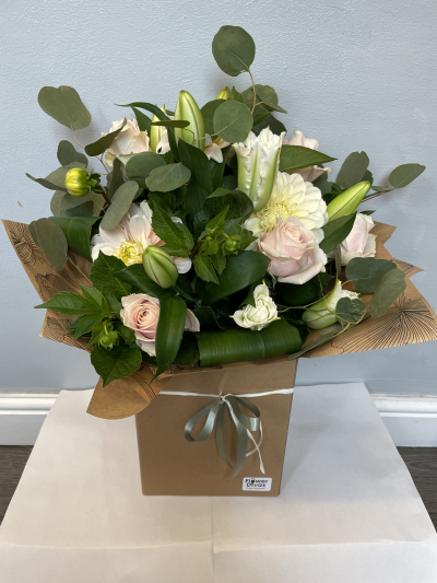 Blushing Elegance - A soft and sophisticated arrangement featuring delicate blush and creamy tones complemented by lush greenery. Presented in a stylish gift bag, this elegant design makes a beautiful choice for birthdays, anniversaries or any special occasion.